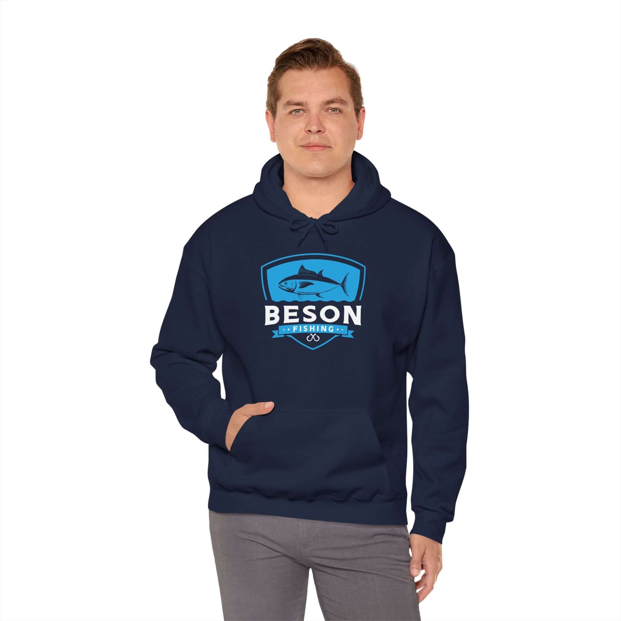 Man wearing Beson Fishing unisex hoodie in navy, featuring spacious pocket and cotton-polyester blend for comfort.